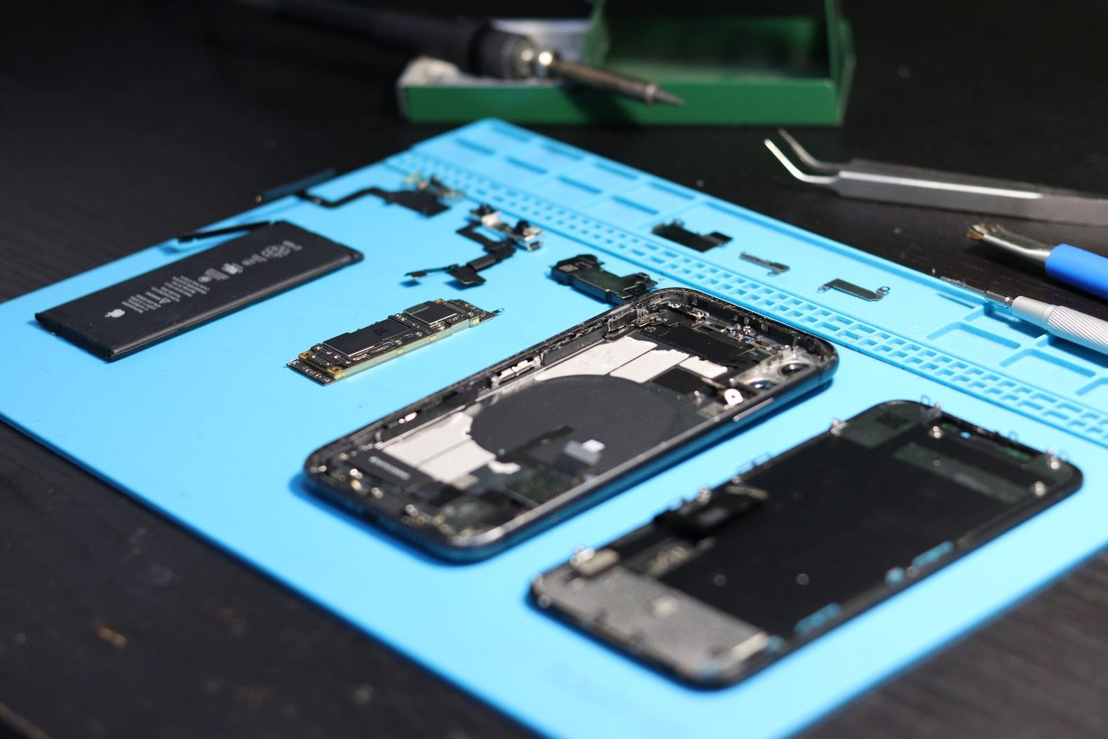 Small electronic parts laid out on a magnetic repair mat